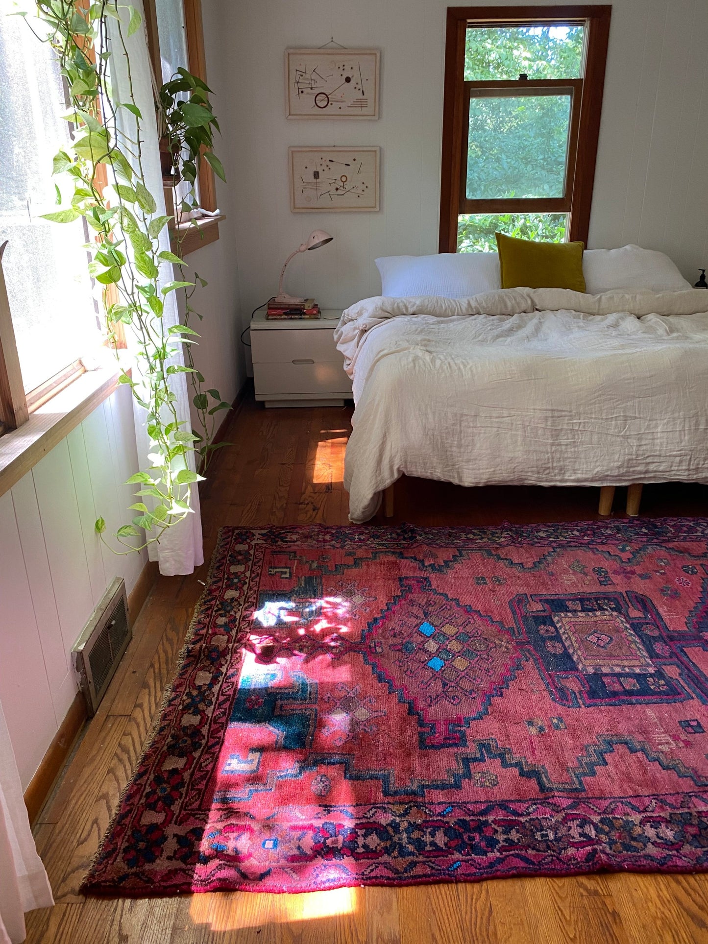 Handwoven vintage rug. Woven with a terracotta field featuring central motifs in indigo, fuscia, cacao, and pops of azul. In good vintage condition.