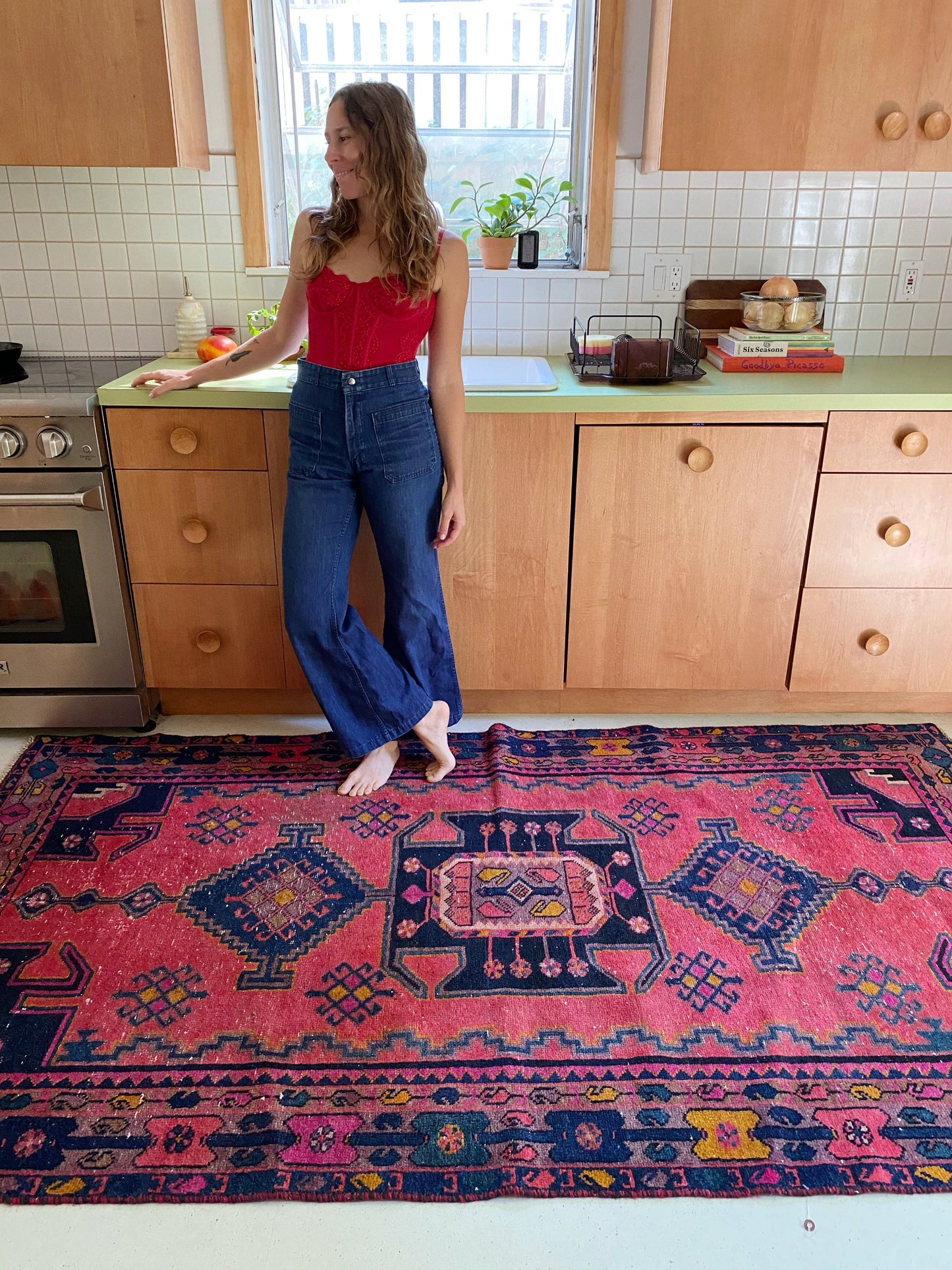Tamarind Persian Rug has a warm field of pinks and marigold and indigo