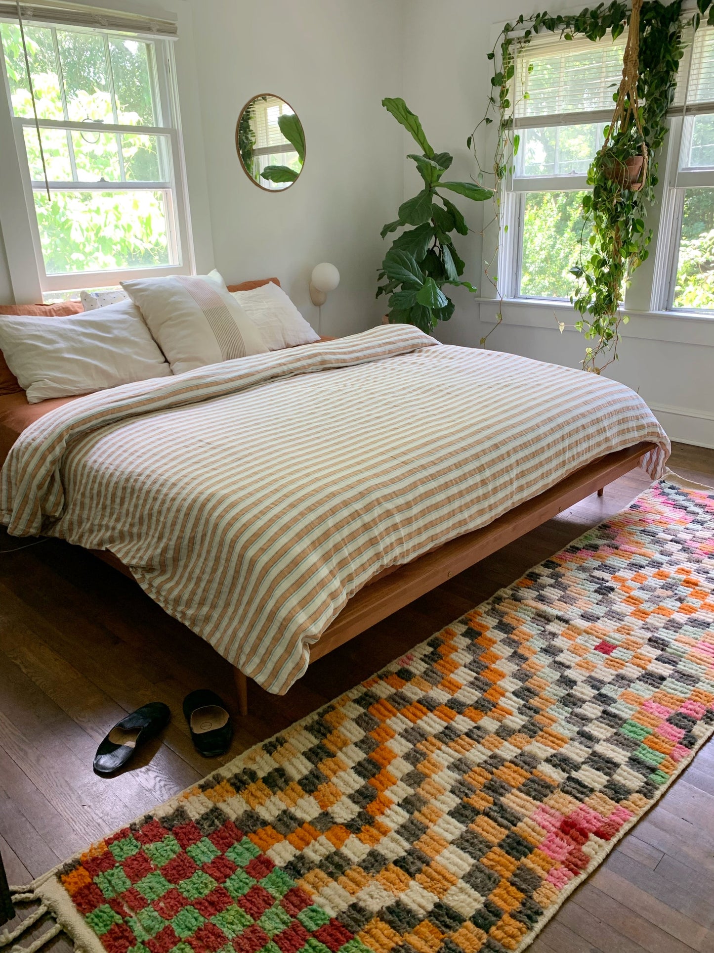 Black slippers and a cozy Moroccan runner make a room inviting