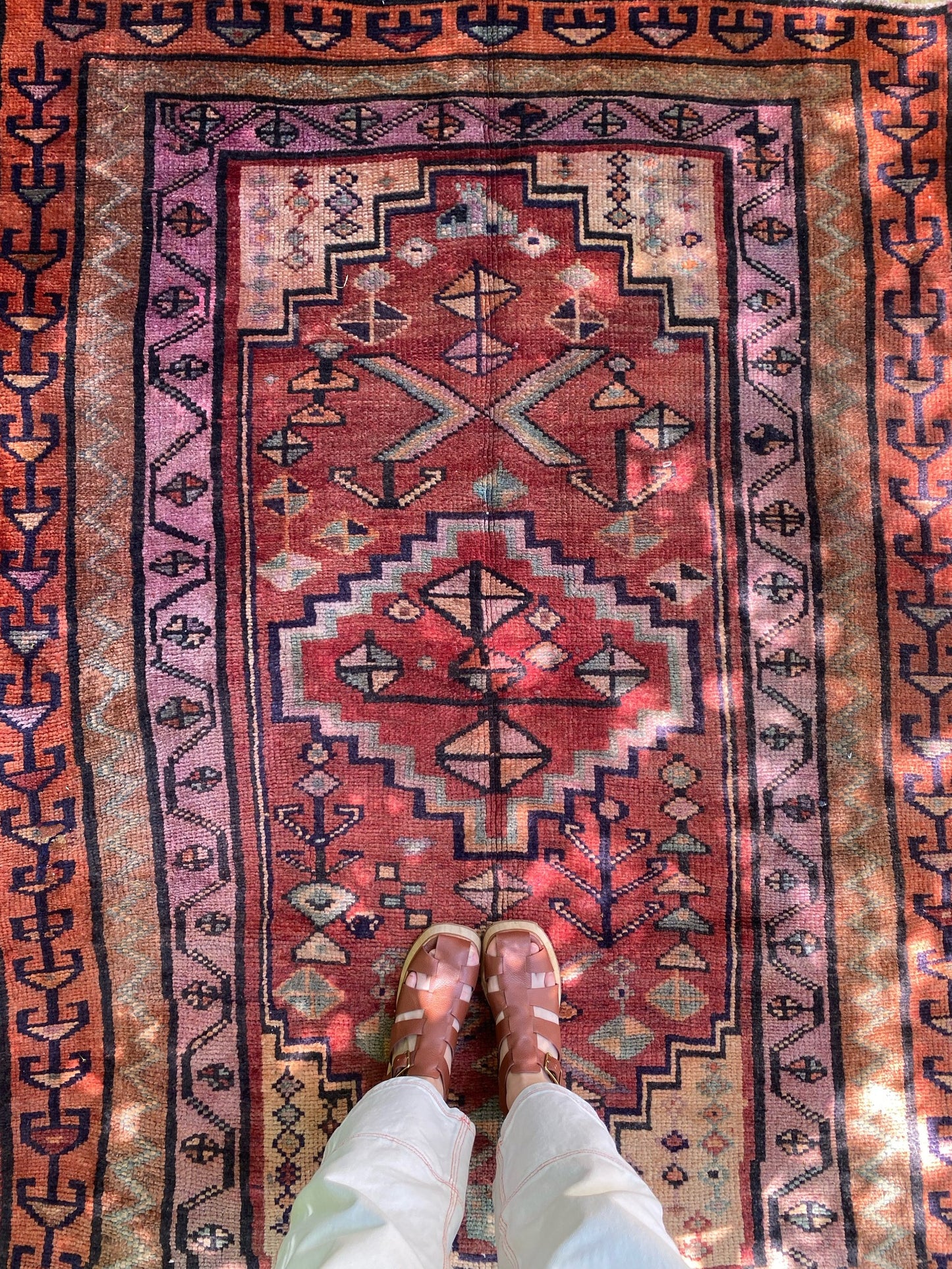 See Details of Vintage Persian Rug and Evil Eye Motifs in Dappled Light
