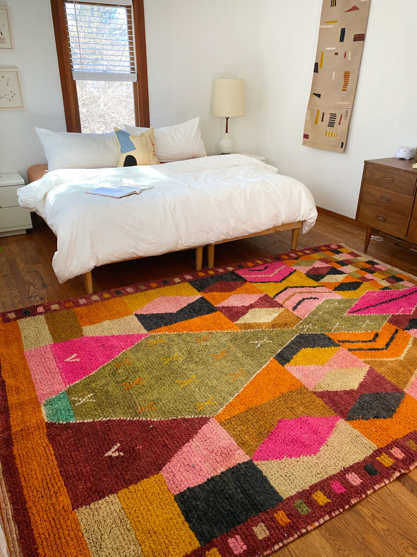 Irregular shaped area rug styled in a bedroom