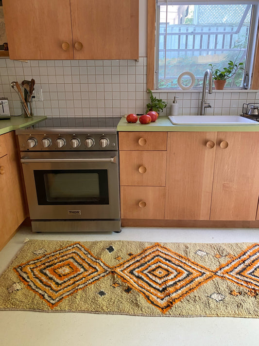 Moroccan runner handwoven with gold, orange and black diamonds.