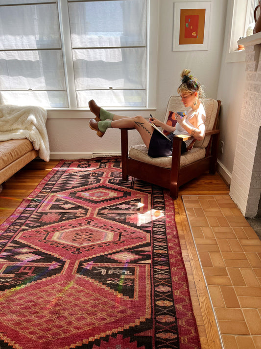 Lovely Persian rug adorns a living room and adds pops of color.
