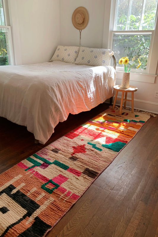 A gorgeous runner rug shines in the sunshine.