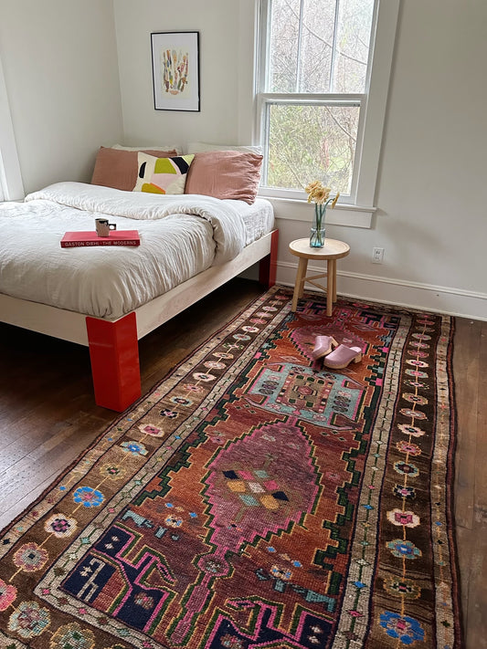 a gorgeous persian rug next to a semi exact bed frame | Lost hunt vintage