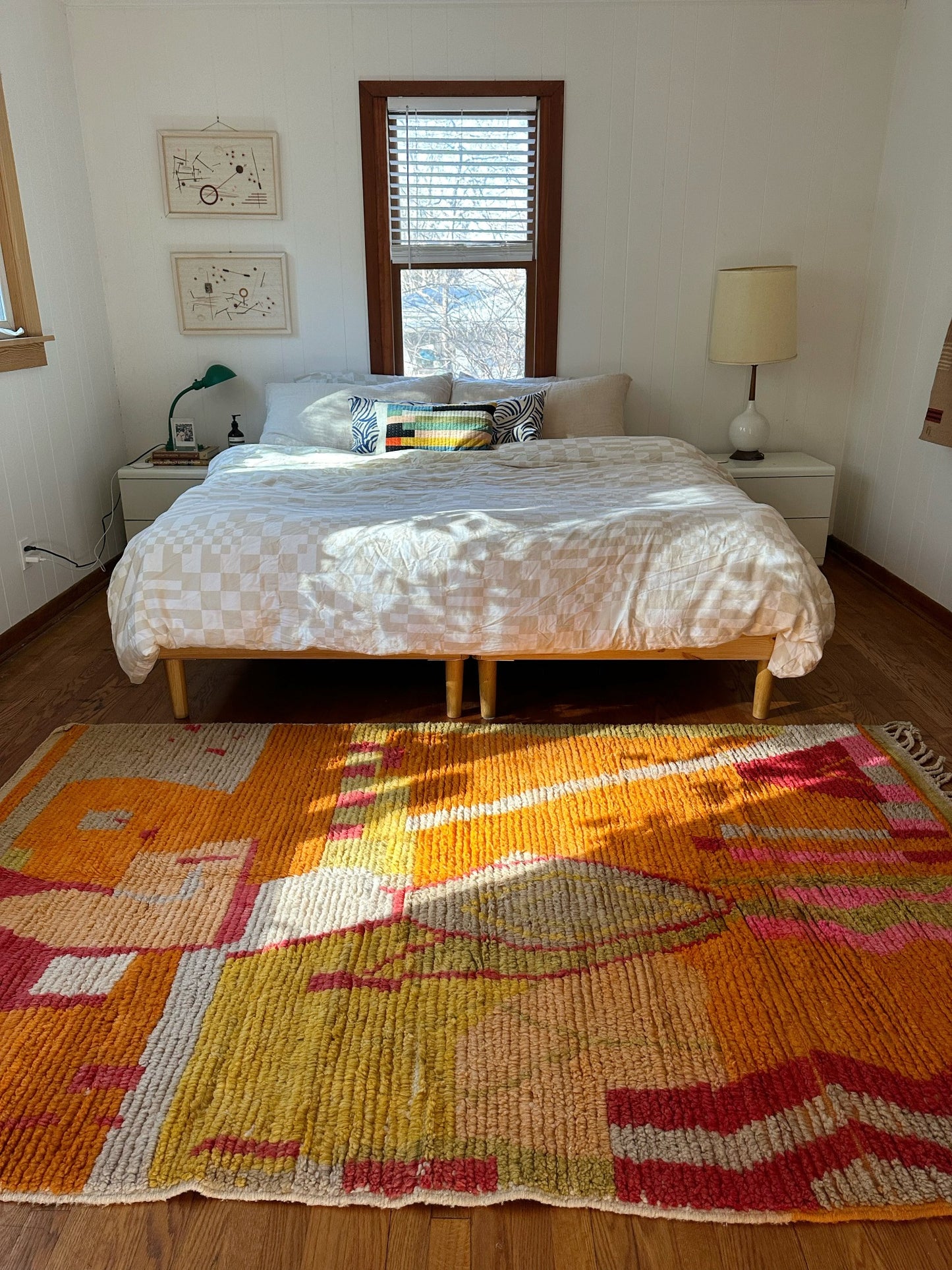 multi colored rug with tassels styled next to a King bed
