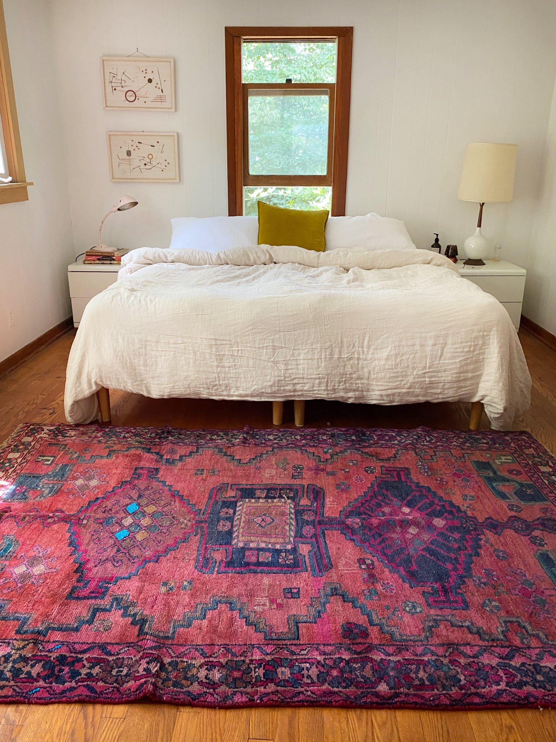 Oak Persian Rug at the foot of a bed makes the room a special space