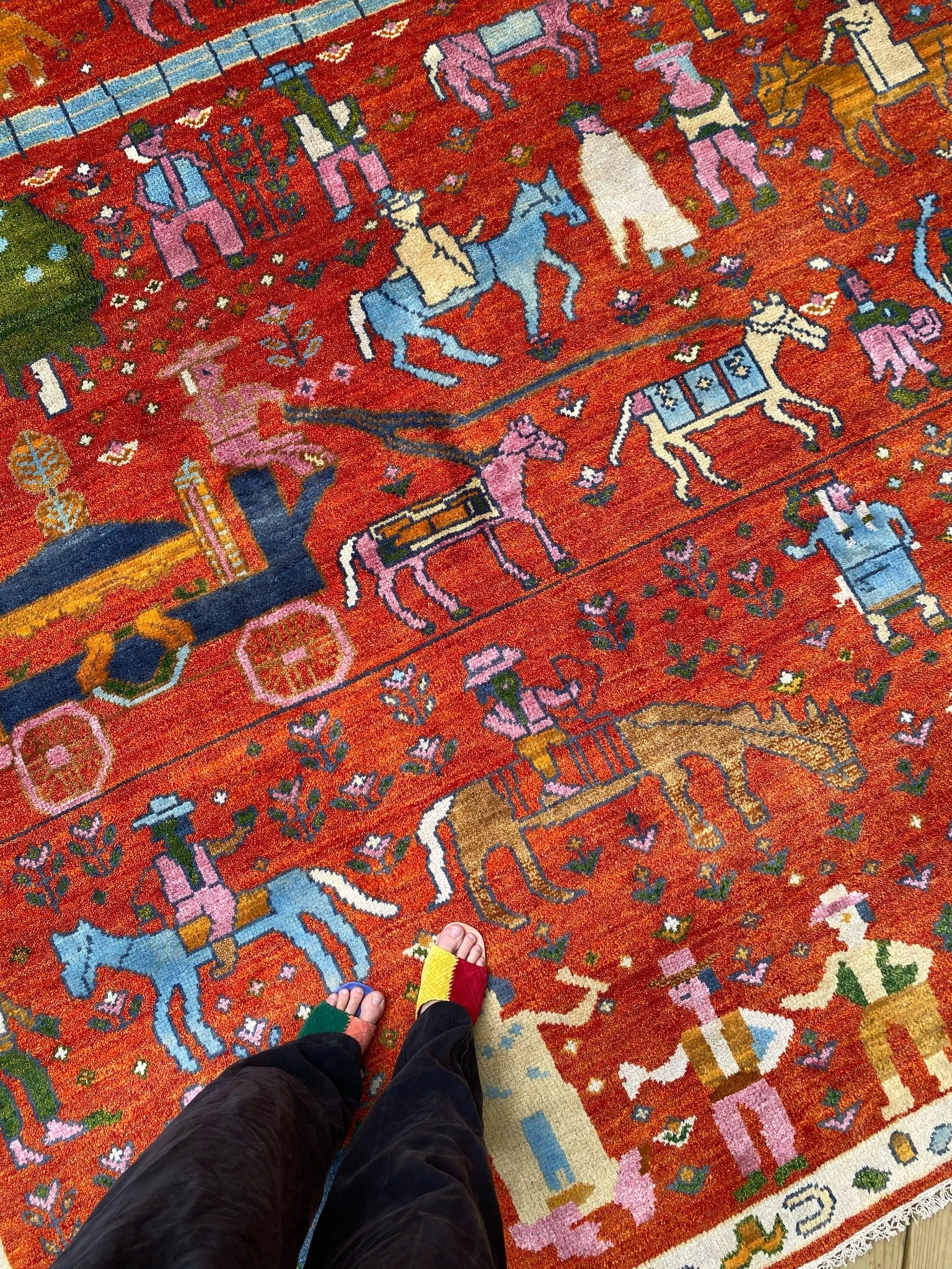 See Folk Village Motifs on Red Vintage Rug