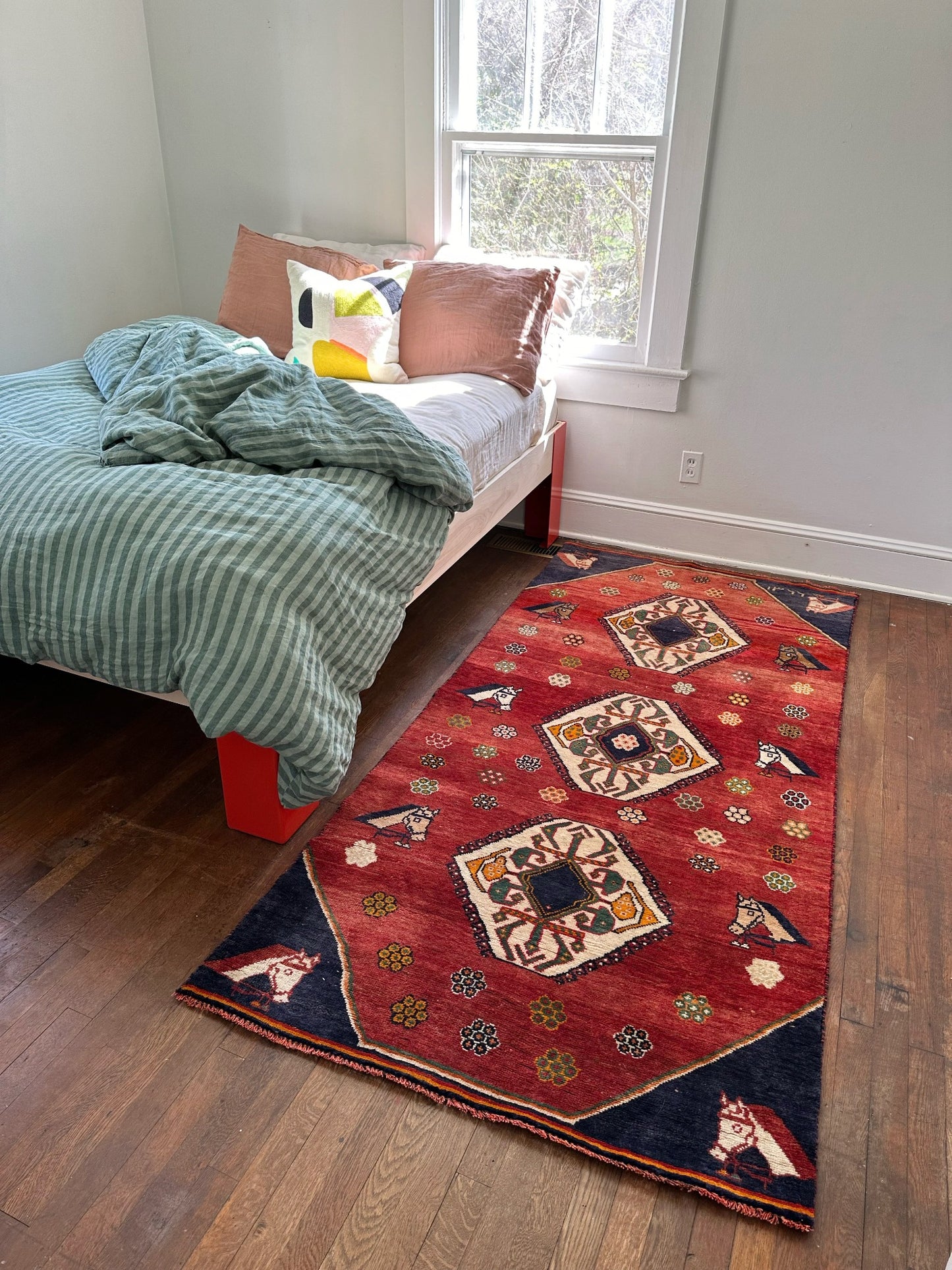 Style Basseri Red Horse Motif Rug in a Bedroom