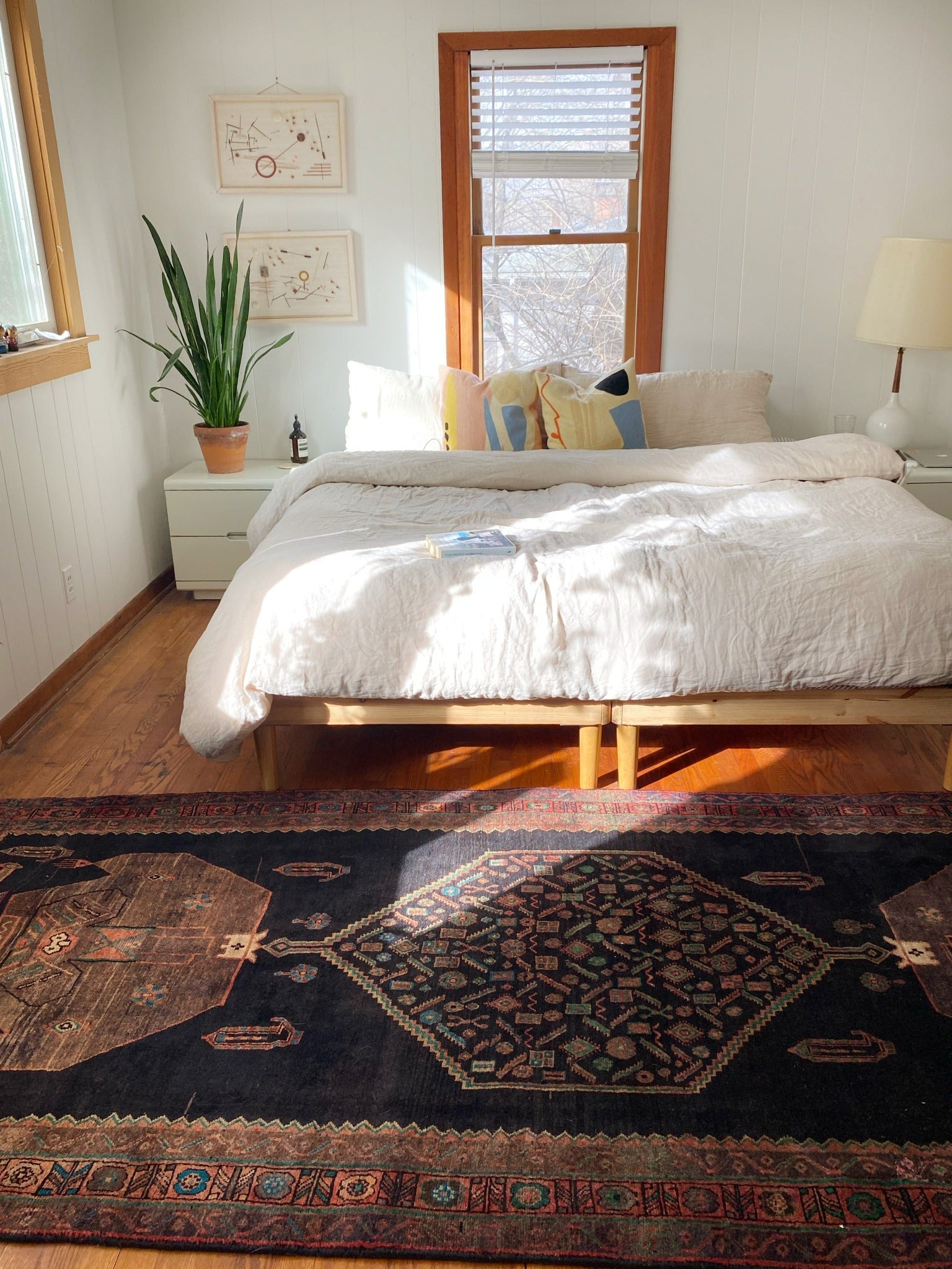 Exquisite rugs and vintage Palm Persian Rug Styled in a Bedroom