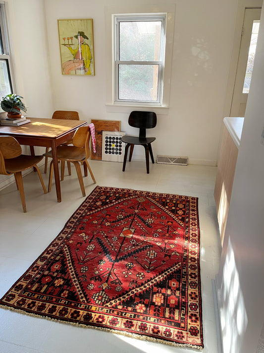 See a Red Vintage Persian Rug in a Dining Room