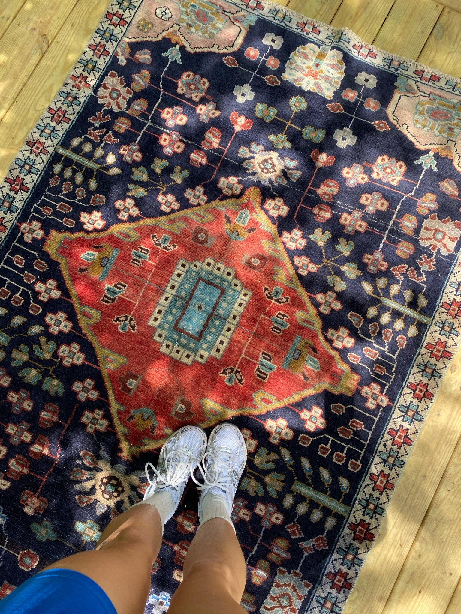 See Vintage Persian Rug and Floral Motifs From Overhead in Dappled Light