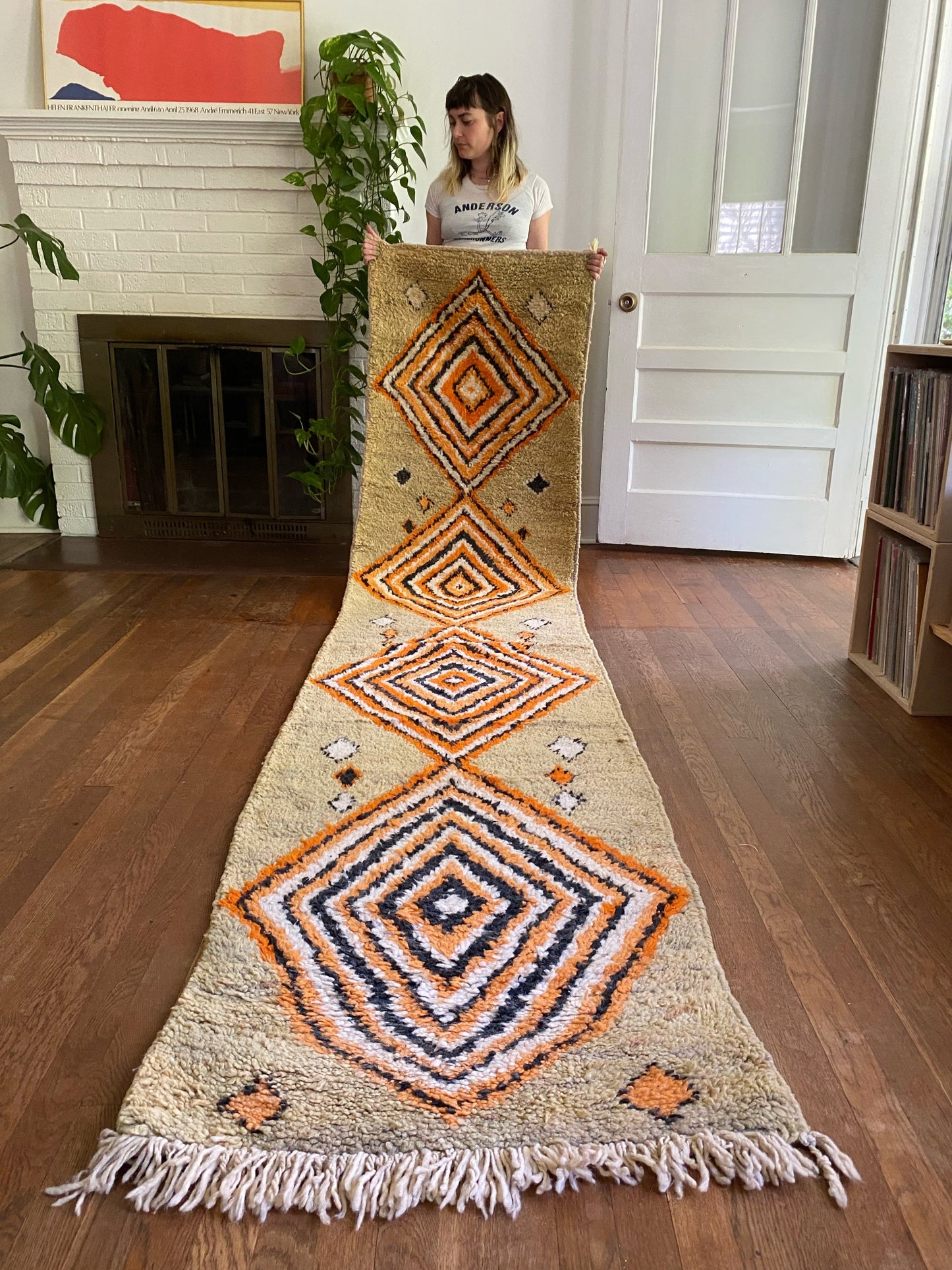 Pini Moroccan Runner is held showing the four big diamond motifs