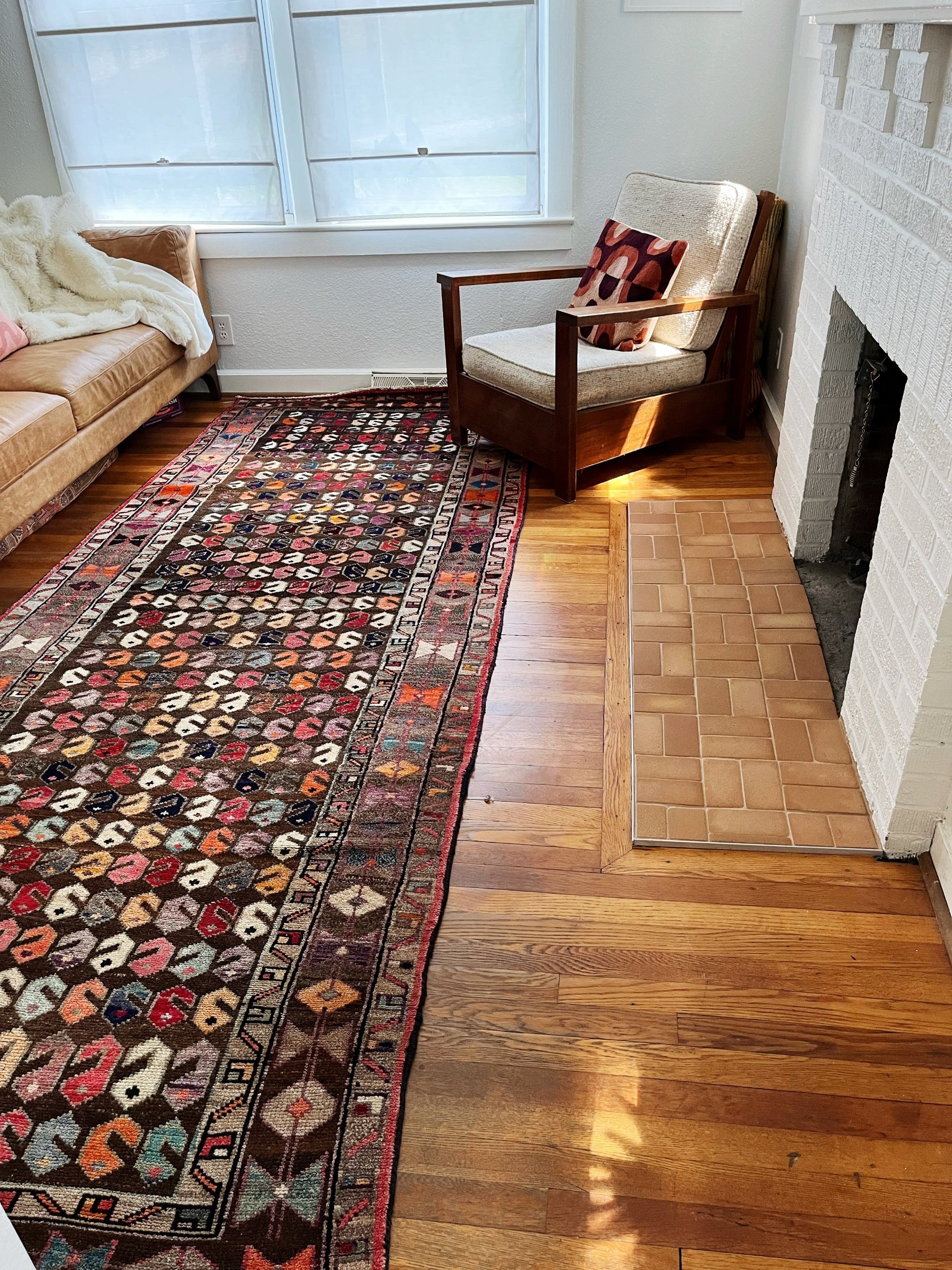 The Dina Persian rug presents charming motifs that would create a lovely atmosphere in a living room, bedroom, or kitchen