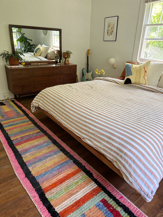 Adding a rug to a bedroom brings warmth and depth.