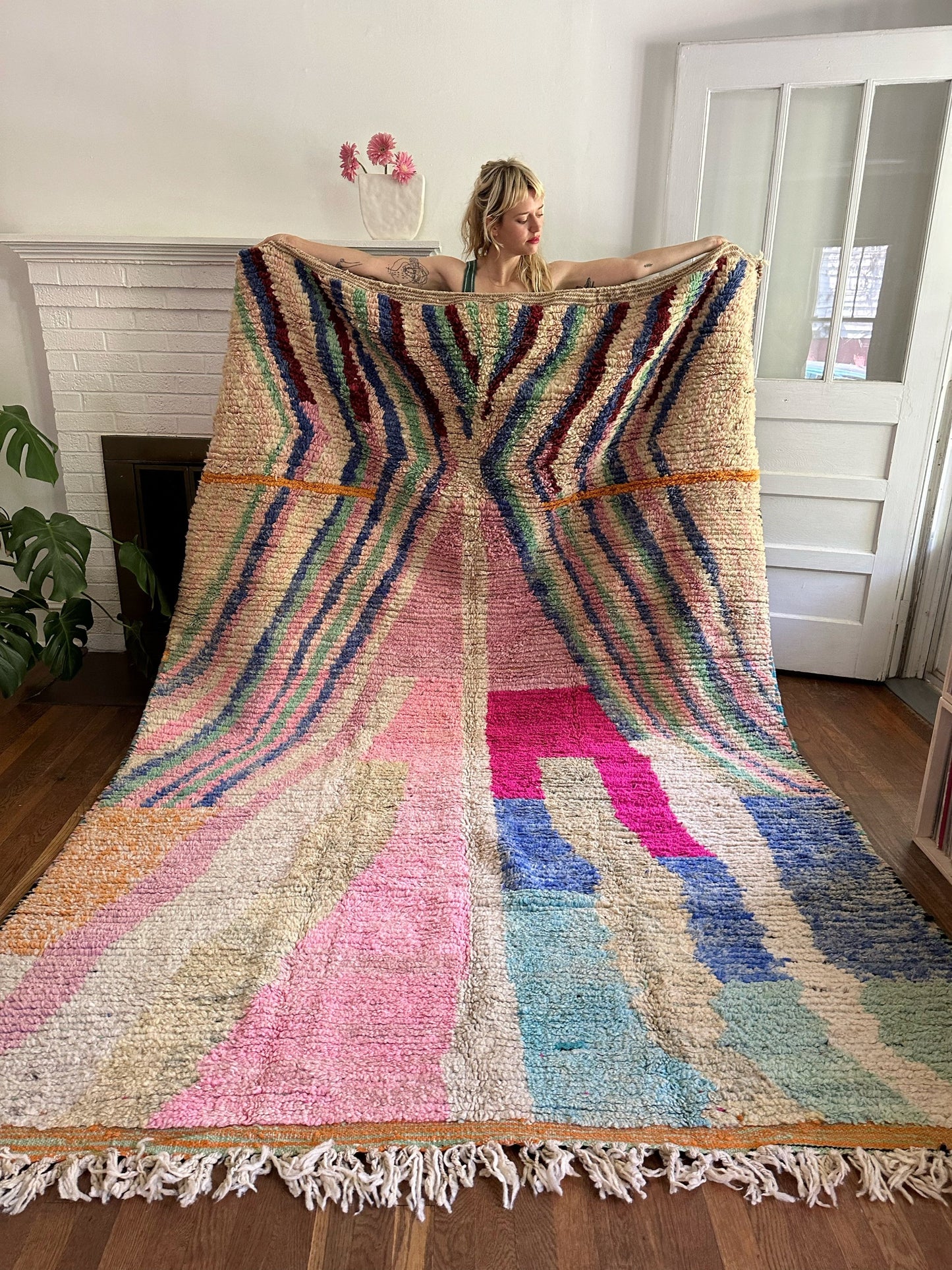 Flora Moroccan Rug is held to see how bright and fluffy it is