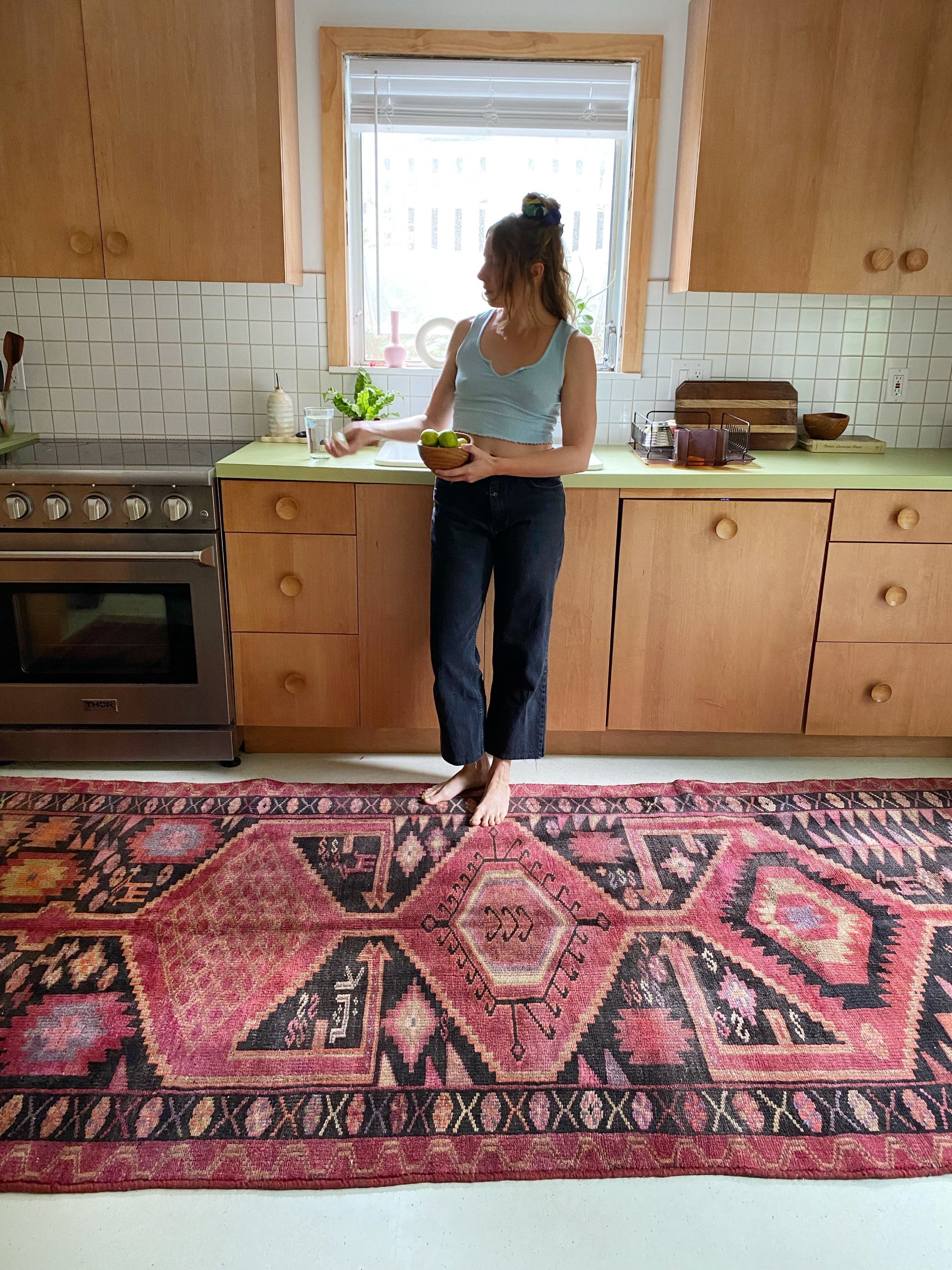 A beautiful Persian rug enhances the kitchen and introduces vibrant splashes of color