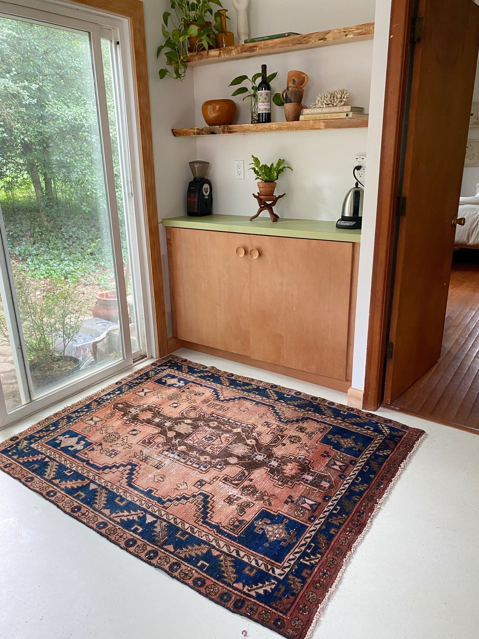 Indigo and peach make this vintage persian rug pop in a modern kitchen.